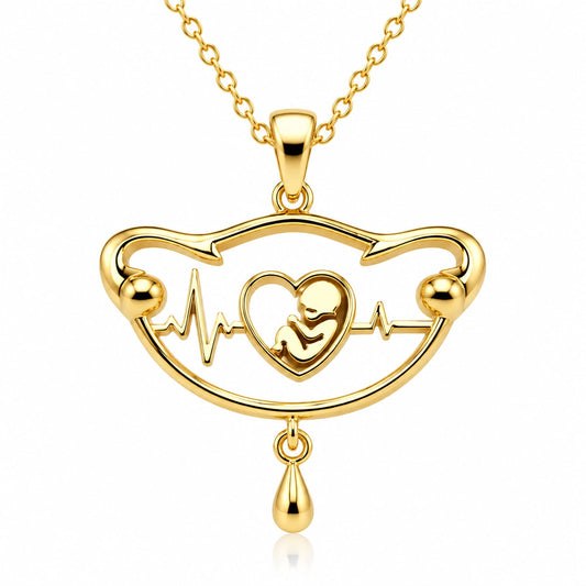 Gold uterus-shaped pendant cradling a baby silhouette, The First Heartbeat memorial necklace by Moses Beau